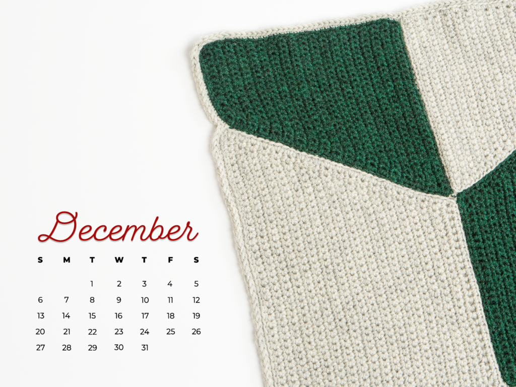 The edge of a crocheted blanket and a December 2021 calendar
