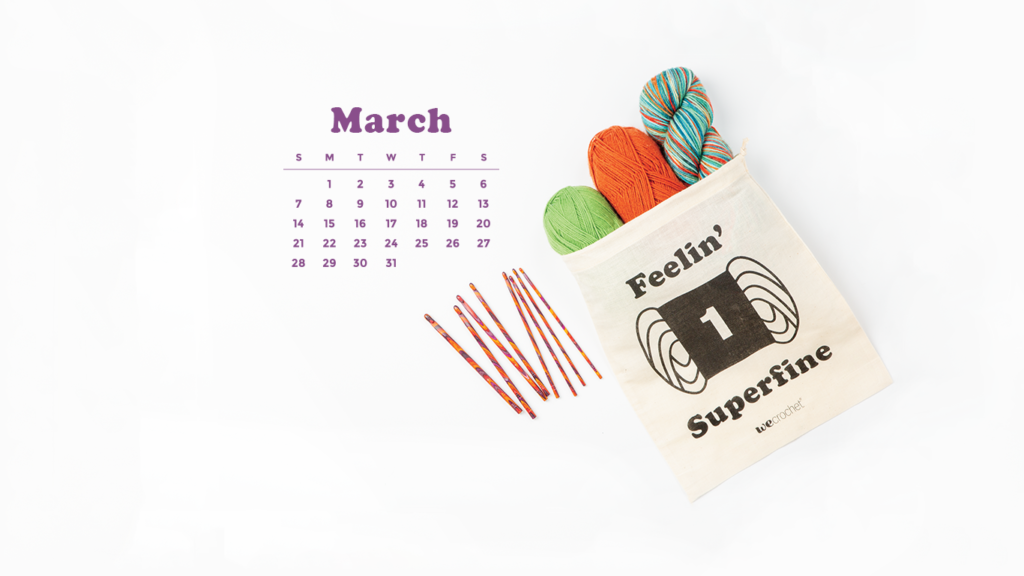 A white background with the March 2021 calendar. A cream-colored project bag that says "Feelin' Superfine" with a yarn weight 1 icon, filled with colorful yarn. A set of colorful orange/purple Radiant wooden crochet hooks is next to the bag.