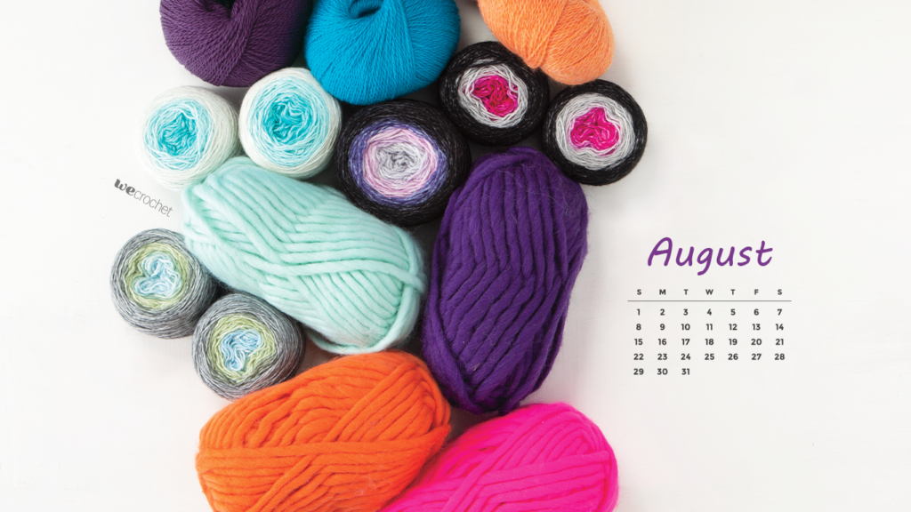 A pile of various colorful yarn in sage, electric blue, eggplant, orange, and fuchsia with an August 2021 calendar