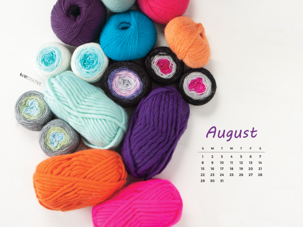 A pile of various colorful yarn in sage, electric blue, eggplant, orange, and fuchsia with an August 2021 calendar