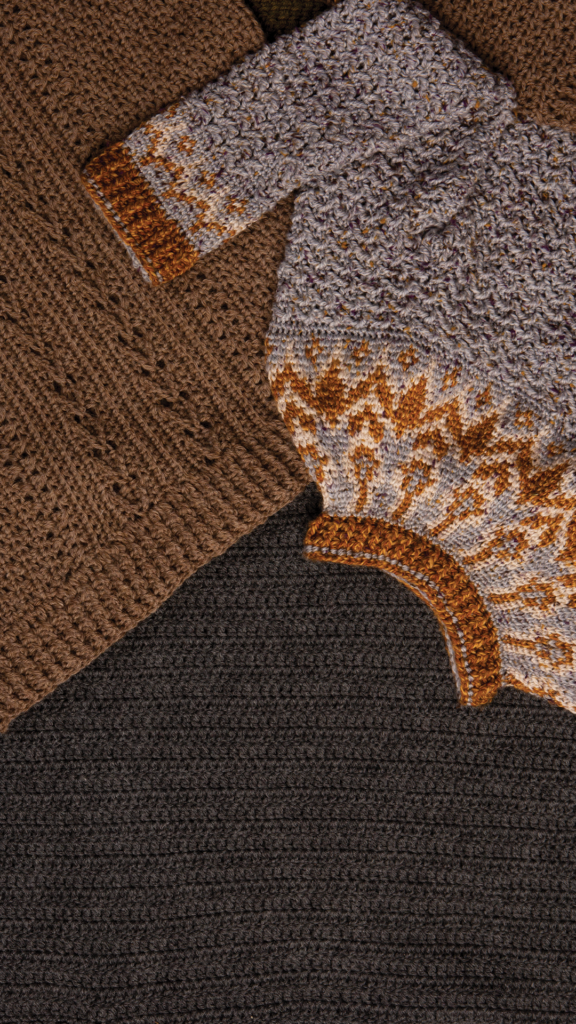Two crocheted sweaters overlapping (one brown, one gray with a patterned yoke)