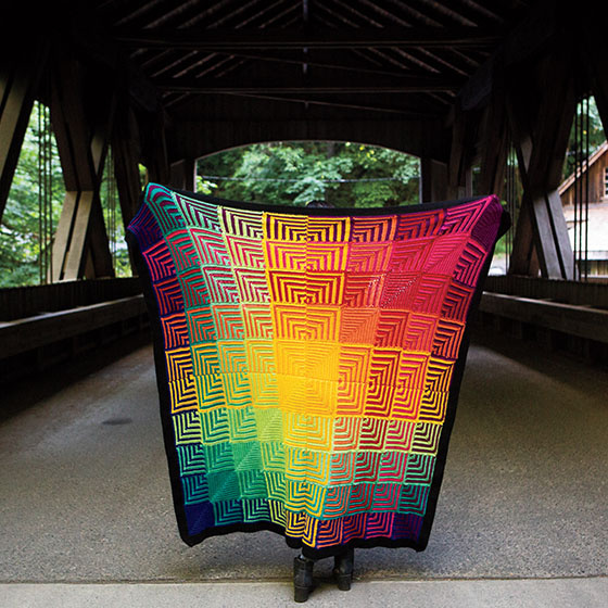 The Hue Shift Afghan is a rainbow-colored crochet blanket.