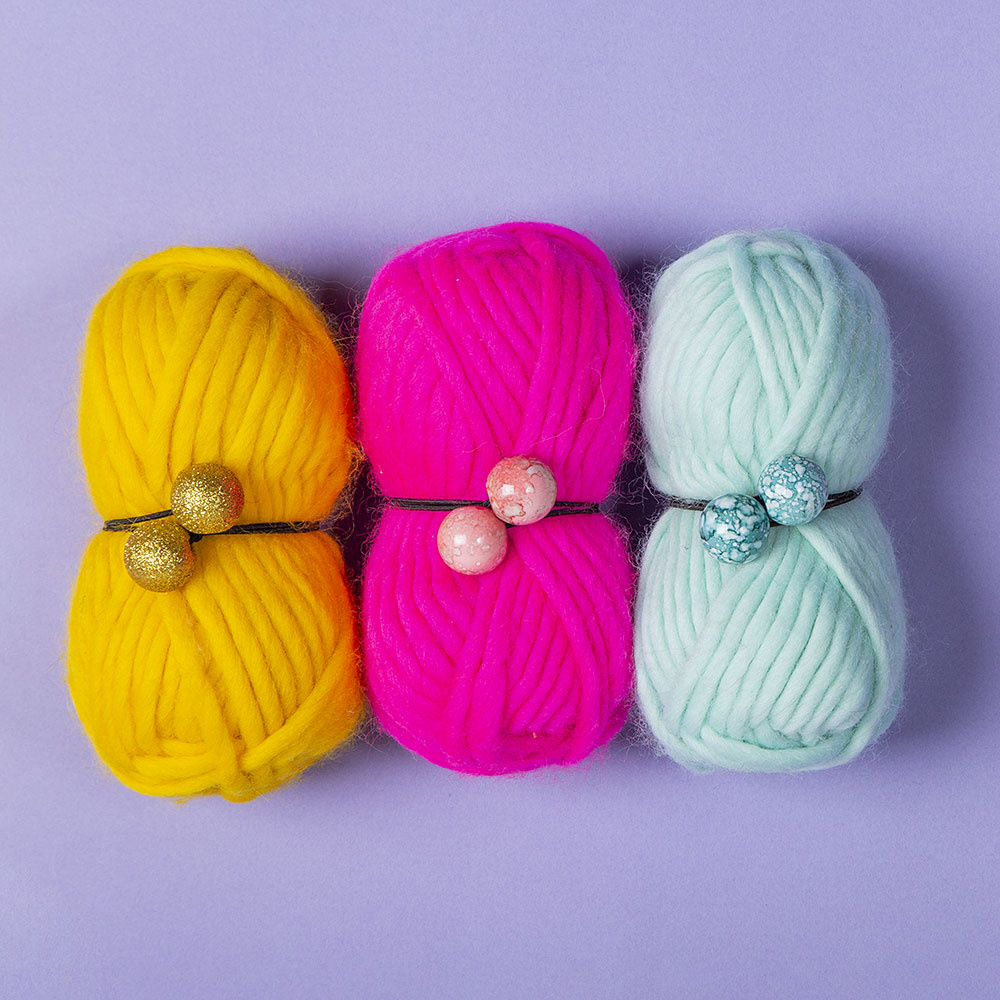 10 Thrifty Crochet Tips from the WeCrochet Blog at crochet.com. This photo shows: The Hook Nook Skein Savers, which are ball-ended elastics wrapped around yarn skeins.