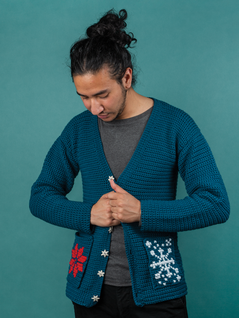 A model wears the Revelry crochet cardigan, a free holiday crochet pattern from crochet.com. A not-ugly sweater for the holidays.