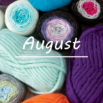 A pile of various colorful yarn with the text "August"